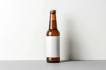 Beer Bottle Mockup. Brown beer bottle with a blank label on a gray surface.
