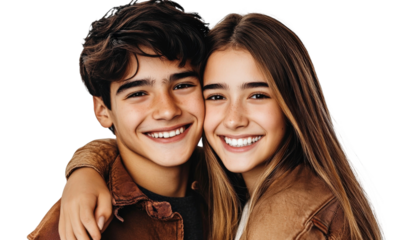 Joyful teenage siblings embracing with big smiles, capturing a moment of happiness and connection in a light-hearted portrait against a simple background