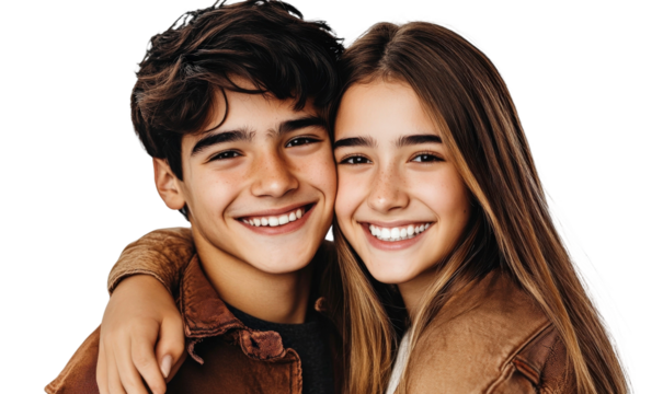 Joyful teenage siblings embracing with big smiles, capturing a moment of happiness and connection in a light-hearted portrait against a simple background