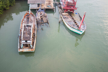 Aerial view of old wooden fishing boats in the sea, Thailand.