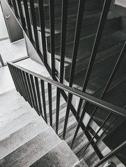 Staircase with black railings, concrete steps, modern architecture, monochrome scheme