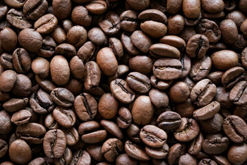 Roasted coffee beans close-up macro shot.Rough textured background pattern.