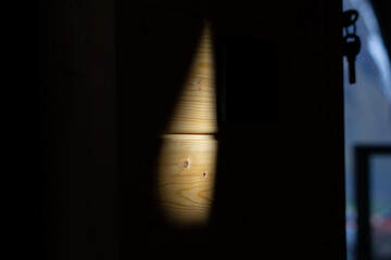 The shadow of a window on a dark wooden wall