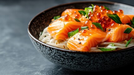 A beautifully arranged bowl featuring salmon sashimi and noodles topped with salmon roe, green onions, and sesame seeds, highlighting Japanese culinary artistry.
