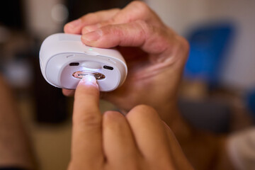 Close-up of an electric nail clipper in hand, modern personal care technology, highlighting compact...
