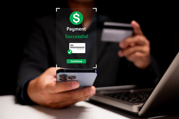 A person completes a successful online payment using a credit card and smartphone near a laptop.