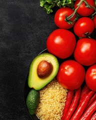 Fresh Vegetables and Ingredients for Healthy Cooking on Black Surface