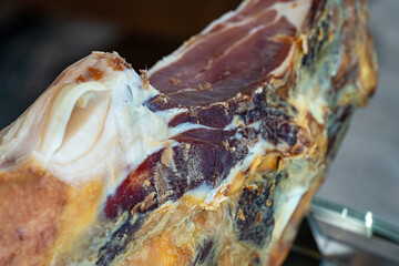 Photo of dried cured meat leg ready for slicing. The rich texture and deep color highlight this...
