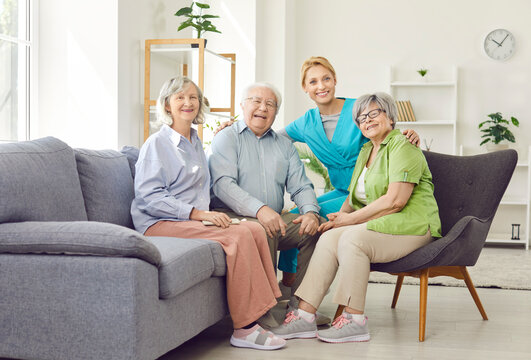 Portrait of a happy caregiver and a diverse group of elderly patients in a nursing home. This image highlights the care and support provided by nurses in senior living environments.
