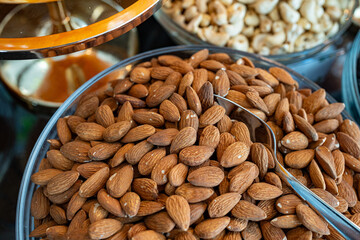 Photo of a heap of almonds served in a bowl at a restaurant. The close-up shot highlights the...
