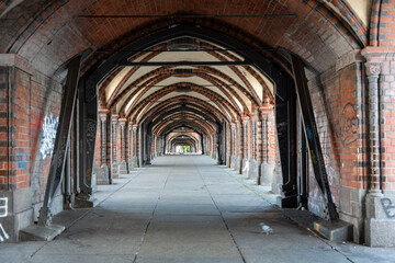A long covered passageway with red brick arches extends symmetrically into the distance. The famous...