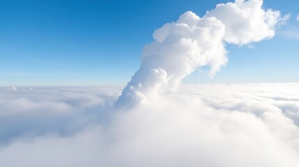 Fototapeta premium A stunning view of a towering cloud formation piercing through the blue sky, creating a dramatic natural spectacle.