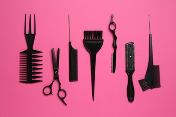 Different hairdresser's tools on pink background, flat lay