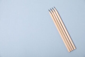 Many graphite pencils on grey background, flat lay. Space for text