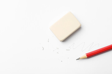 Pencil, eraser, doodle and scraps on white background, flat lay. Space for text