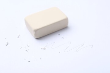 Eraser, doodle and scraps on white background, selective focus