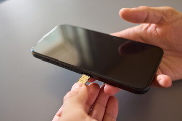 Detailed Process of Installing a SIM Card Utilizing Various Smartphone Components and Accessories