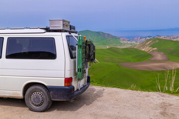 Travel Van carrying equipment on roof rack in mountainous area