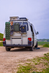 Van carrying equipment in serene rural landscape during daytime
