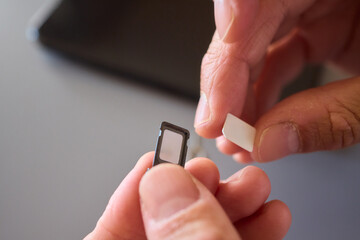 Detailed Process of Installing a SIM Card Utilizing Various Smartphone Components and Accessories