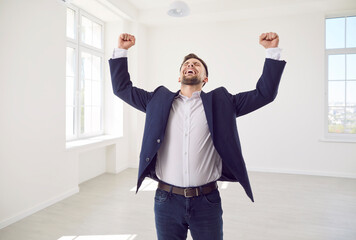 Ecstatic excited male new home owner, happy realtor after real estate deal, signing flat sale,...