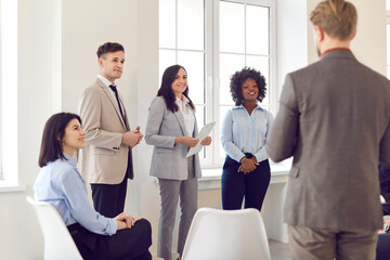 Colleagues listening attentively to a presentation during a meeting or conference in the office....
