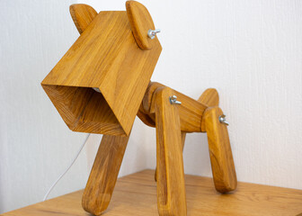 Wooden conceptual lamp on a desk