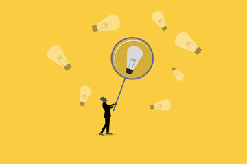 Businessman with Magnifying glass looking idea lightbulb, concept of startup idea and problem solving