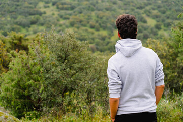 Young man on his back contemplating calmly the Nature of a forest