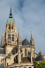 Fototapeta premium Bayeux Cathedral, exterior mid shot of the copper clad spire in the sunshine 