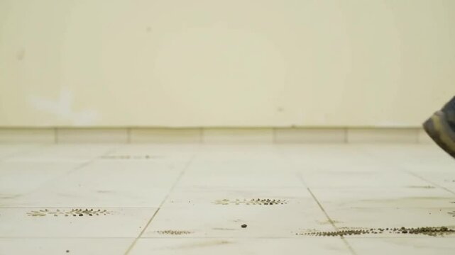 Trampling dirty work boots on a lightcolored floor. Suitable for industrial, construction, cleaning, or renovation concepts in design projects.