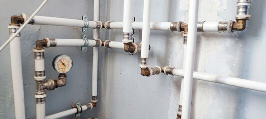 Efficient home plumbing concept: interior water pressure system with PVC piping, metal fittings,...