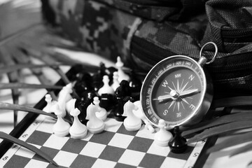 Retro compass and mini chess, entertainment during travel.