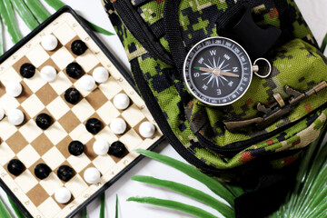 Retro compass and mini chess, entertainment during travel.