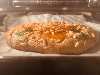 Homemade Sant Joan pastry baking on oven tray.