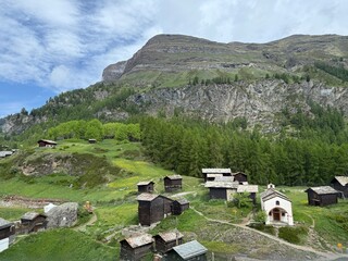 Small Alpine village agains the backdrop of a mountain peak