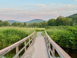 The winding, meandering Windham Path bridge, in summer at dawn. Hike, run, meditate, fish. meadow, creek, stream. mountain, colors and small town countryside vibe.  Charming ski area in the Catskills.