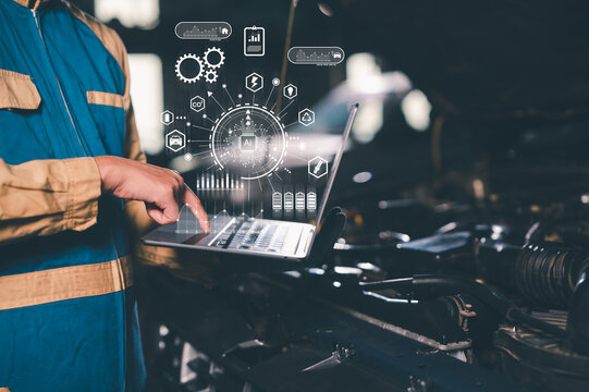 A technician in workwear uses a laptop with digital AI and technology icons, highlighting smart manufacturing and industrial automation.
