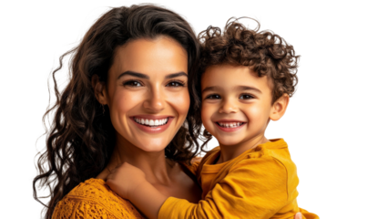 Smiling mother holding joyful boy in cozy yellow attire showcasing love and happiness in a warm family moment with bright expressions