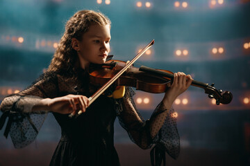 Fototapeta premium girl playing violin on stage