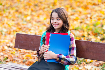 School education. Student girl do homework in autumn. Autumn time to study. School girl get...