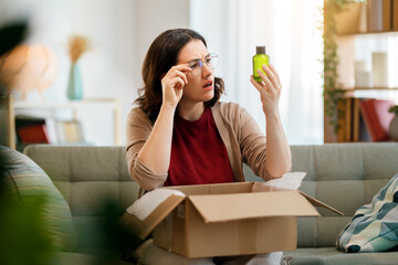 Woman is unpacking cardboard