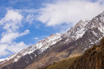 Majestic snow-covered mountains in serene daytime setting