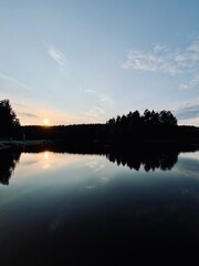 warm sunset reflection on the lake surface, beautiful sunset at the lake in the countryside, summer peaceful evening