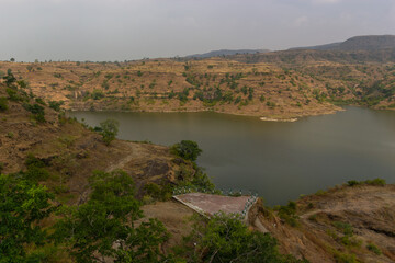 Scenic Lake Surrounded by Hills and Vegetation