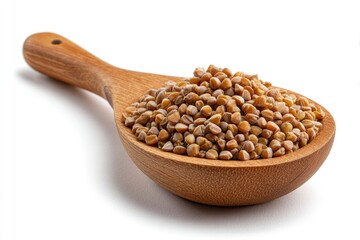 Wooden spoon filled with pile of tan buckwheat grains studio shot