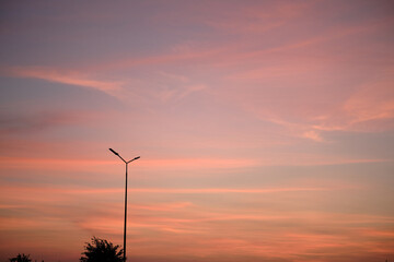Street lantern on the background of a colorful sky during sunset. Romantic atmosphere in the evening