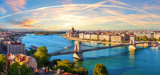 Chain bridge over Danube River in Budapest at sunset, with Parliament and Margaret Island, beautiful panorama of Hungary