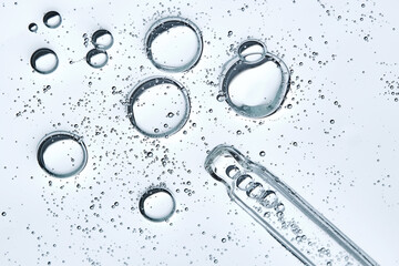 The texture of hyaluronic serum with lots of bubbles with a pipette.
