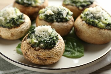 Tasty stuffed mushrooms served on table, closeup